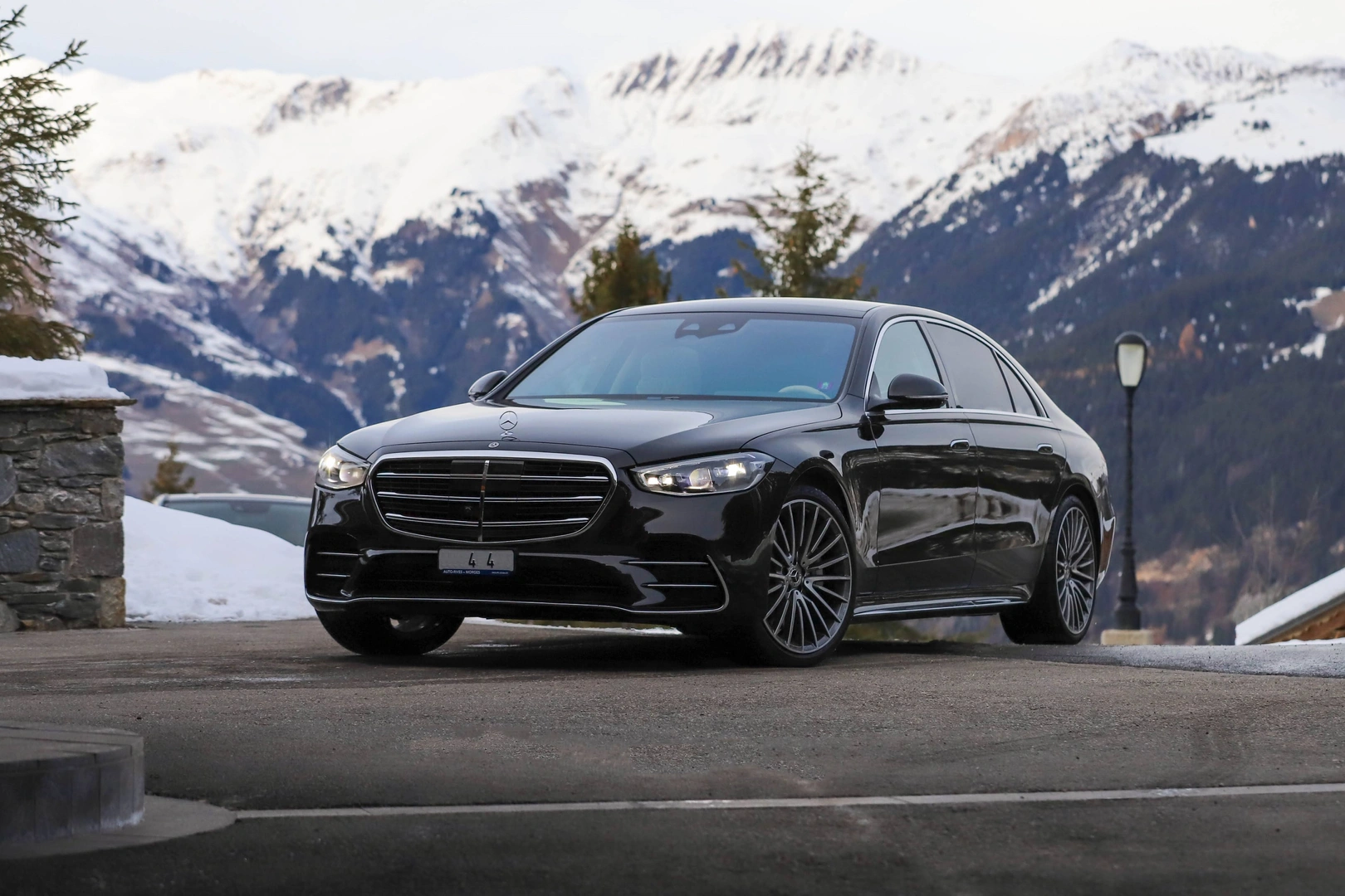 Luxury car parked in a scenic alpine location