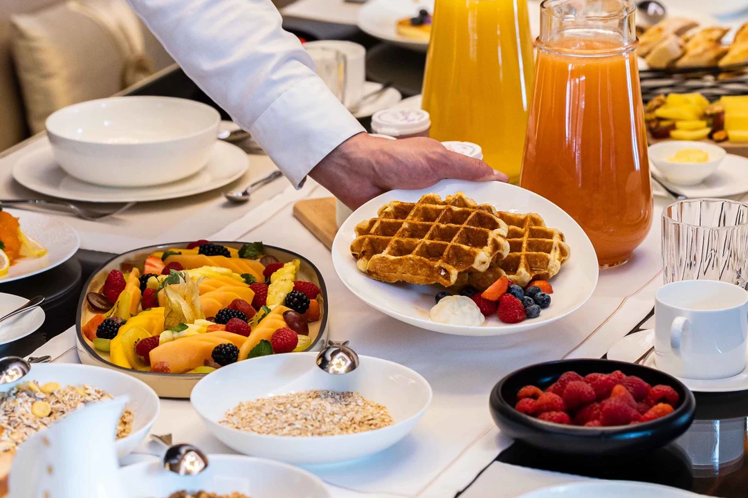 A welcoming breakfast nook with a spread of freshly baked pastries, fruits, and hot beverages.